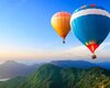 Two-hot-air-balloons-mountains-sky_1280x1024.jpg