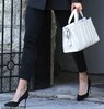 29084506-8377201-On_the_go_She_carried_a_1_540_white_leather_bag_by_Max_Mara_in_h-m-33_1591032...jpg