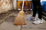 woman-sweep-leaves-and-soil-into-bin-photo.jpg