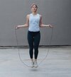 young-sportswoman-skipping-rope-while-standing-royalty-free-image-1622111905.jpg
