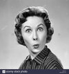 1950s-woman-making-funny-face-eyes-wide-lips-pursed-as-in-a-kiss-or-AAKR3R.jpg